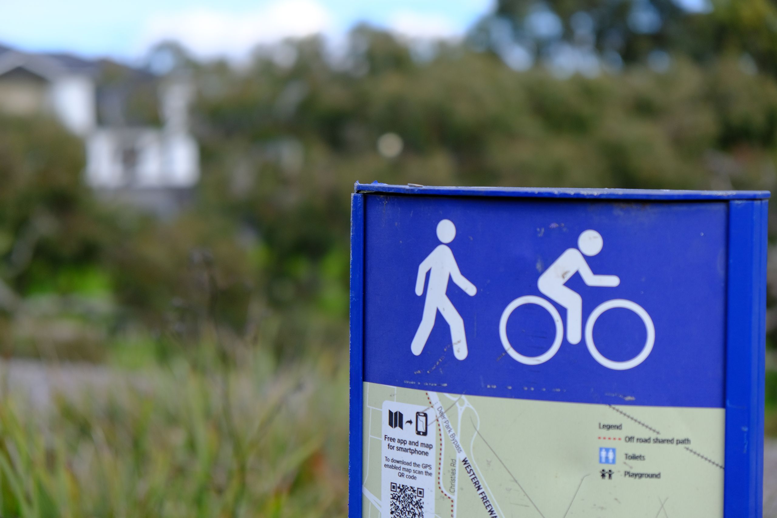 A closeup of a sign showing a map for a walking and cycling trail